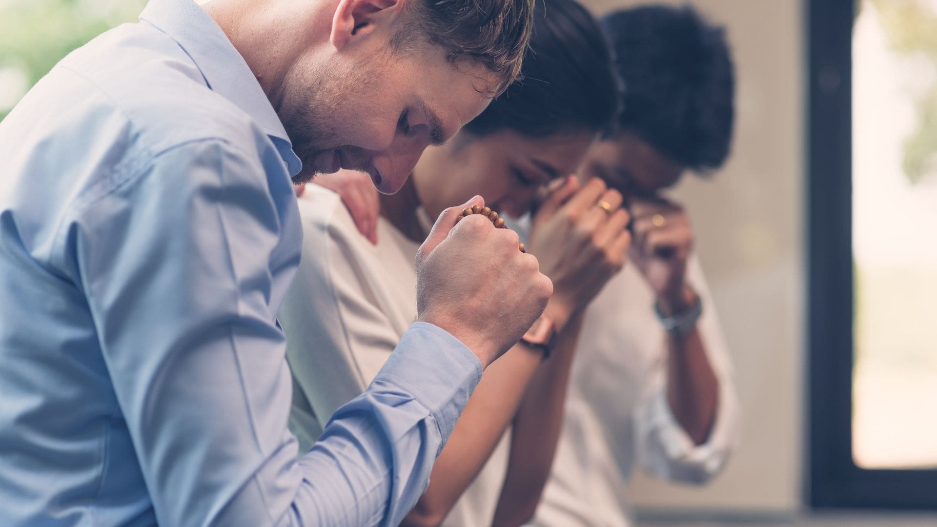 People praying together in a church, experiencing peace and unity through prayer
